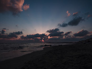 Scenic view of beach against sky during sunset