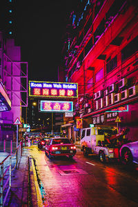 Cars on city street at night