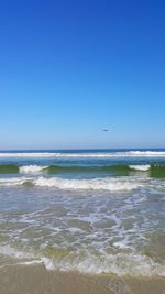 Scenic view of sea against clear blue sky