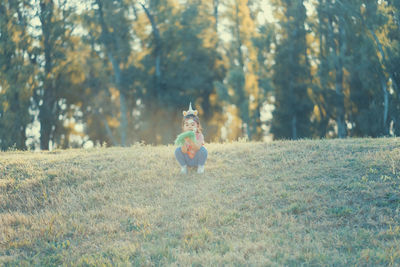Little girl sitting on the grass
