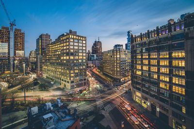 High angle view of city lit up at night