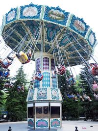 Low angle view of ferris wheel against building