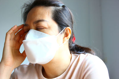 Close-up portrait of woman covering face