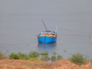 Fishing boat moored on sea shore