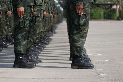 Low section of soldiers walking on street