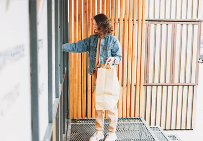 Full length of woman holding food standing outdoors