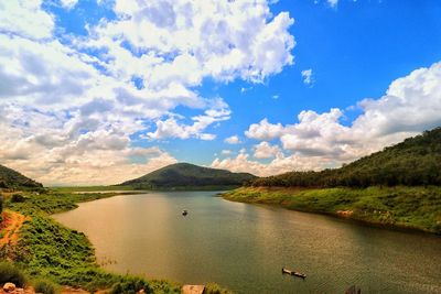 Scenic view of lake against cloudy sky