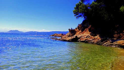 Scenic view of sea against clear blue sky