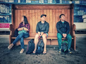 Portrait of two people sitting on bench