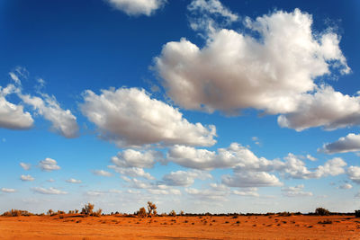 Scenic view of desert against blue sky