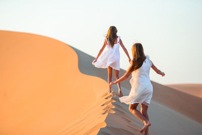 Woman with umbrella walking on land