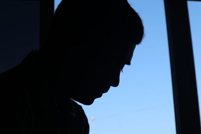 Close-up portrait of silhouette man against sky