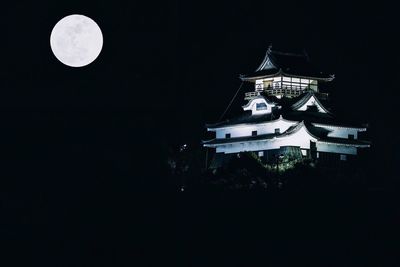 Low angle view of illuminated lights against clear sky at night