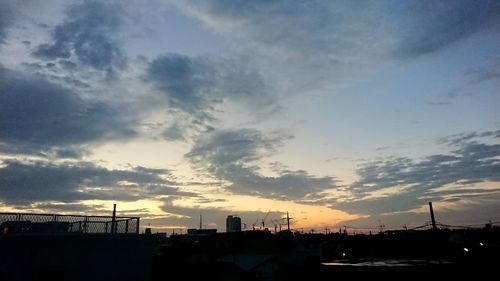 Silhouette buildings against sky during sunset