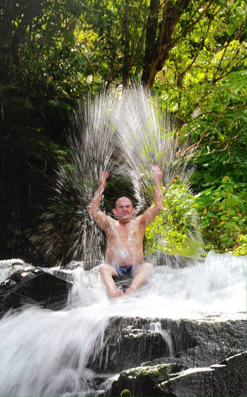 water, motion, waterfall, splashing, lifestyles, flowing water, long exposure, leisure activity, nature, animal themes, one animal, flowing, blurred motion, day, outdoors, green color, men, plant