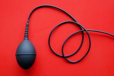 High angle view of eyeglasses on table against red background