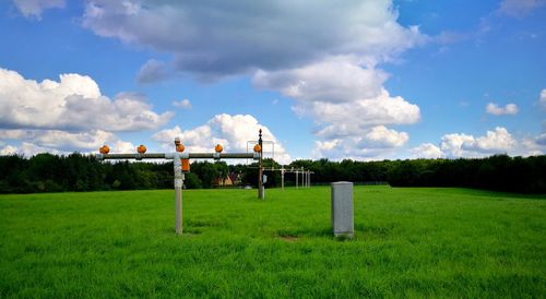 Traditional windmill on field against sky