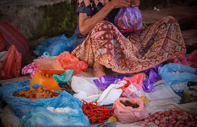 Low section of woman selling food at street