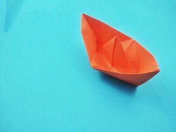 Paper boat on blue background