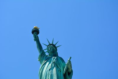 Low angle view of statue of liberty against sky