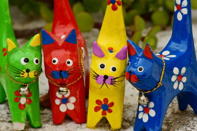 Hand made toys in intense colour yellow blue red green against flat colour background