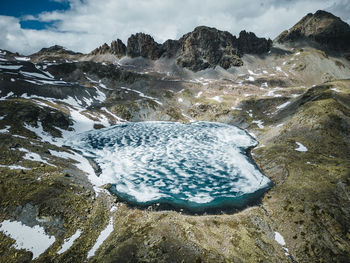 Aerial image of frozen tscheppa lake or lej da la tscheppa above silvaplana, engadin, switzerland