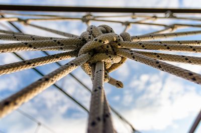 Close-up of rope tied to metal fence