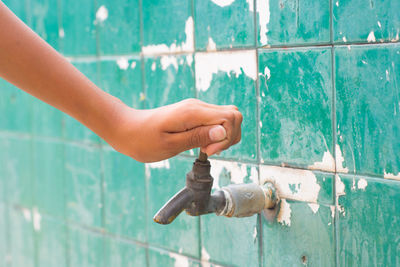 Close-up of hand against water