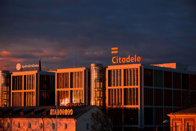 Illuminated building against sky at dusk