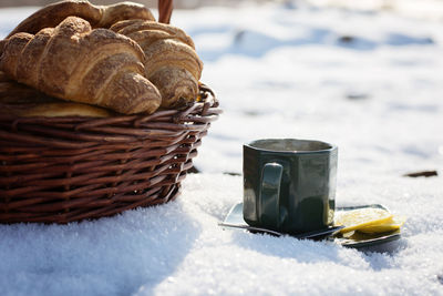 Close-up of tea cup in snow