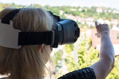 Rear view of woman with virtual reality simulator