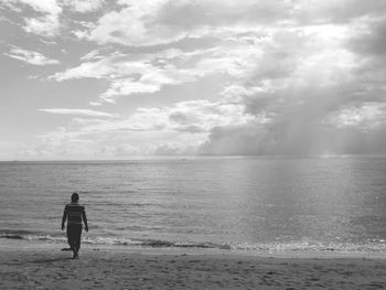 Rear view of person standing on beach