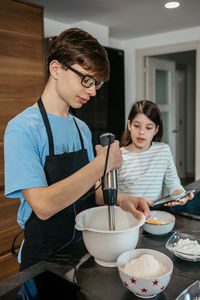 Side view of young man preparing food at home