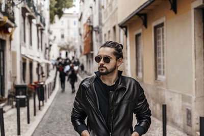 Young man wearing sunglasses in city