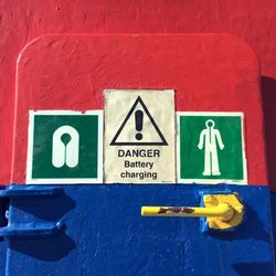 Warning sign on painted metallic door