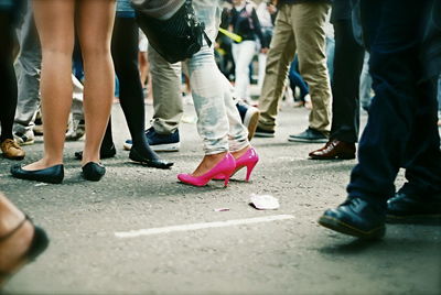 Low section of people standing on tiled floor