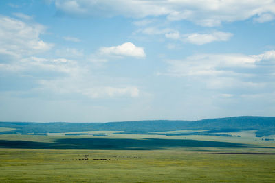 Scenic view of landscape against cloudy sky