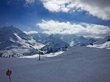 Scenic view of snow covered mountains against sky