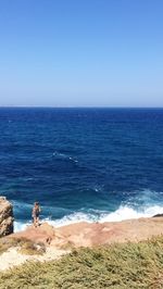 Scenic view of sea against clear blue sky