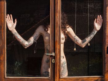 Naked woman seen through window