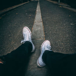 Low section of man sitting on road