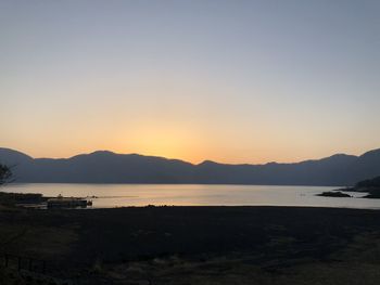 Scenic view of sea against clear sky during sunset