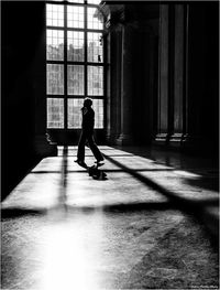 Full length of silhouette man walking in building