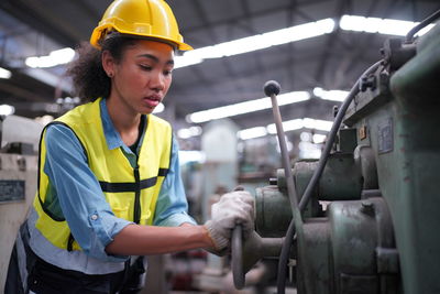 Rear view of man working in factory