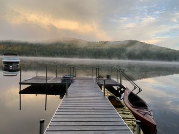 Pier over lake against sky