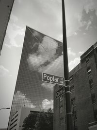 Low angle view of modern building against cloudy sky