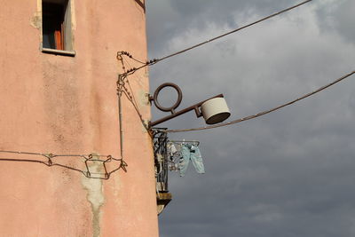 Low angle view of telephone pole against sky