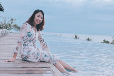 Portrait of smiling woman sitting outdoors