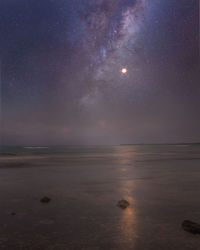 Scenic view of sea against sky at night