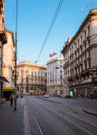 Street amidst buildings in city against sky